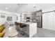 Modern kitchen featuring a stylish island with bar seating and stainless steel appliances, connecting to dining area at 10291 Se 67Th Ter, Belleview, FL 34420
