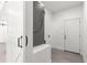 A clean laundry area with a barn door, utility sink, and access to an exterior door at 10291 Se 67Th Ter, Belleview, FL 34420
