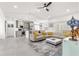 Open-concept living room and kitchen featuring modern furnishings, bright neutral colors, and a seamless flow at 10291 Se 67Th Ter, Belleview, FL 34420