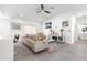 Spacious living room featuring modern furnishings, sleek floors, and bright, neutral decor with eye-catching artwork at 10291 Se 67Th Ter, Belleview, FL 34420