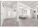Bright, open-concept space with white walls, gray floors, and multiple doorways at 10291 Se 67Th Ter, Belleview, FL 34420