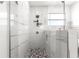 A stylish walk-in shower featuring decorative accent tiles, glass enclosure, and rain shower head at 10291 Se 67Th Ter, Belleview, FL 34420