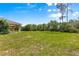 Expansive, grassy backyard offering ample space and privacy surrounded by lush trees and greenery at 10313 Sw 45Th Ave, Ocala, FL 34476
