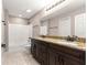 Bathroom with double vanity, granite countertop, and a shower with white subway tile at 10313 Sw 45Th Ave, Ocala, FL 34476