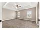 Bedroom with plush carpet, ceiling fan, and natural light from two windows at 10313 Sw 45Th Ave, Ocala, FL 34476