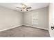 Bedroom featuring a ceiling fan, plush carpet, and a window for natural light at 10313 Sw 45Th Ave, Ocala, FL 34476
