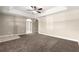 Spacious bedroom featuring tray ceilings, a ceiling fan, neutral paint, and arched doorways at 10313 Sw 45Th Ave, Ocala, FL 34476