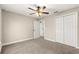 A bedroom featuring carpeted floors, fan and a closet for storage space at 10313 Sw 45Th Ave, Ocala, FL 34476