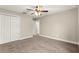 Bedroom with fan, closet, neutral walls and soft carpet flooring at 10313 Sw 45Th Ave, Ocala, FL 34476