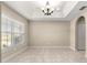 Dining room with tile floors, bright light fixture and a window bringing in natural light at 10313 Sw 45Th Ave, Ocala, FL 34476