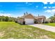 Exterior view showcasing a two-car garage and landscaping, nestled on a well-maintained lawn at 10313 Sw 45Th Ave, Ocala, FL 34476