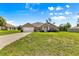 Charming single-story home featuring a well-manicured lawn, attached garage, and classic American flag at 10313 Sw 45Th Ave, Ocala, FL 34476