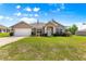Charming single-story home featuring a well-manicured lawn, attached garage, and classic American flag at 10313 Sw 45Th Ave, Ocala, FL 34476