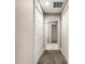 Hallway view showcasing carpet flooring and linen closet at 10313 Sw 45Th Ave, Ocala, FL 34476