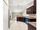 Kitchen area with granite countertops, tiled flooring, and dark wood cabinetry at 10313 Sw 45Th Ave, Ocala, FL 34476