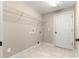 Laundry room with white shelving, tile floors, and a white door at 10313 Sw 45Th Ave, Ocala, FL 34476