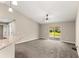 A living room with a ceiling fan and sliding glass doors leading to the backyard at 10313 Sw 45Th Ave, Ocala, FL 34476