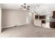 A large living room flows into a kitchen with pendant lights and a breakfast bar at 10313 Sw 45Th Ave, Ocala, FL 34476