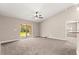 A bright living room with a ceiling fan and sliding glass doors leading to the backyard at 10313 Sw 45Th Ave, Ocala, FL 34476