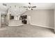 A carpeted living room flows into the kitchen, featuring pendant lights and ample space at 10313 Sw 45Th Ave, Ocala, FL 34476