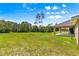 Covered patio, perfect for outdoor seating and relaxation with serene views of the green backyard at 10313 Sw 45Th Ave, Ocala, FL 34476