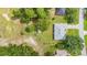 Aerial view of a home with a gray roof situated on a well-maintained lot with a storage shed at 10716 Sw 53Rd Cir, Ocala, FL 34476