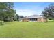 Expansive backyard showcasing lush green lawn extending from home, ample greenery and trees at 10716 Sw 53Rd Cir, Ocala, FL 34476