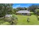 Large backyard featuring a tan house, a shed, and mature trees providing ample shade at 10716 Sw 53Rd Cir, Ocala, FL 34476