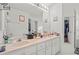 Spacious bathroom features double sinks with a bright mirror and neutral decor at 10716 Sw 53Rd Cir, Ocala, FL 34476