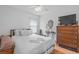 Bright bedroom boasts hardwood floors, a ceiling fan and an ample amount of sunlight at 10716 Sw 53Rd Cir, Ocala, FL 34476