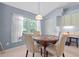 Cozy breakfast nook featuring a round table with marble top, surrounded by neutral colored chairs, by a bright window at 10716 Sw 53Rd Cir, Ocala, FL 34476