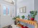 Bright entryway featuring double front doors with decorative glass, a console table, and tiled flooring at 10716 Sw 53Rd Cir, Ocala, FL 34476
