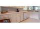 Well-lit kitchen featuring white cabinetry, ample counter space, and a stainless steel sink at 10716 Sw 53Rd Cir, Ocala, FL 34476