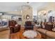 Comfortable living room features hardwood floors, multiple seating arrangements, and seamless flow to the kitchen and dining areas at 10716 Sw 53Rd Cir, Ocala, FL 34476