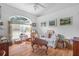 Cozy living room with a large arched window, comfortable seating, and stylish decor at 10716 Sw 53Rd Cir, Ocala, FL 34476