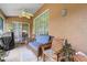 Cozy outdoor patio area with comfortable seating and ceiling fan for relaxing at 10716 Sw 53Rd Cir, Ocala, FL 34476