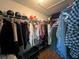 Spacious walk-in closet providing generous storage with hanging clothes and shelves for organization at 10716 Sw 53Rd Cir, Ocala, FL 34476