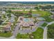 Aerial view of the community pool, tennis courts, and clubhouse at 11237 Sw 78Th Ct, Ocala, FL 34476