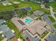 Stunning aerial view of a community center, pool, tennis courts, and green spaces at 11237 Sw 78Th Ct, Ocala, FL 34476