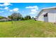 Spacious backyard with a well maintained green lawn and partial fencing at 11237 Sw 78Th Ct, Ocala, FL 34476