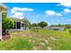 View of large backyard with fencing, screened in patio, and mature trees at 11237 Sw 78Th Ct, Ocala, FL 34476