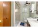 Bathroom featuring a shower with glass doors, a toilet, and tile flooring at 11237 Sw 78Th Ct, Ocala, FL 34476