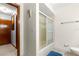 Well-lit bathroom featuring a shower-tub combo with sliding glass doors, tiled floors, and a neutral color scheme at 11237 Sw 78Th Ct, Ocala, FL 34476