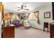 This bedroom is enhanced by natural light, a ceiling fan, and neutral carpet, perfect for relaxation and comfort at 11237 Sw 78Th Ct, Ocala, FL 34476
