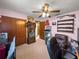 Bedroom featuring a ceiling fan, wood accents, and carpeted floors at 11237 Sw 78Th Ct, Ocala, FL 34476