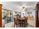 Traditional dining room with a ceiling fan and access to the sunroom and a view into the kitchen at 11237 Sw 78Th Ct, Ocala, FL 34476