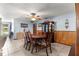 Dining room with wood paneling and a dining table with seating for six at 11237 Sw 78Th Ct, Ocala, FL 34476