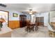 Dining room featuring wainscoting, a dining table with seating, and a china cabinet at 11237 Sw 78Th Ct, Ocala, FL 34476