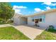 View of the side of the house, featuring a driveway leading to an attached two-car garage at 11237 Sw 78Th Ct, Ocala, FL 34476