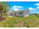 Charming single-story home featuring a well-maintained lawn, blue awnings and attached two-car garage at 11237 Sw 78Th Ct, Ocala, FL 34476